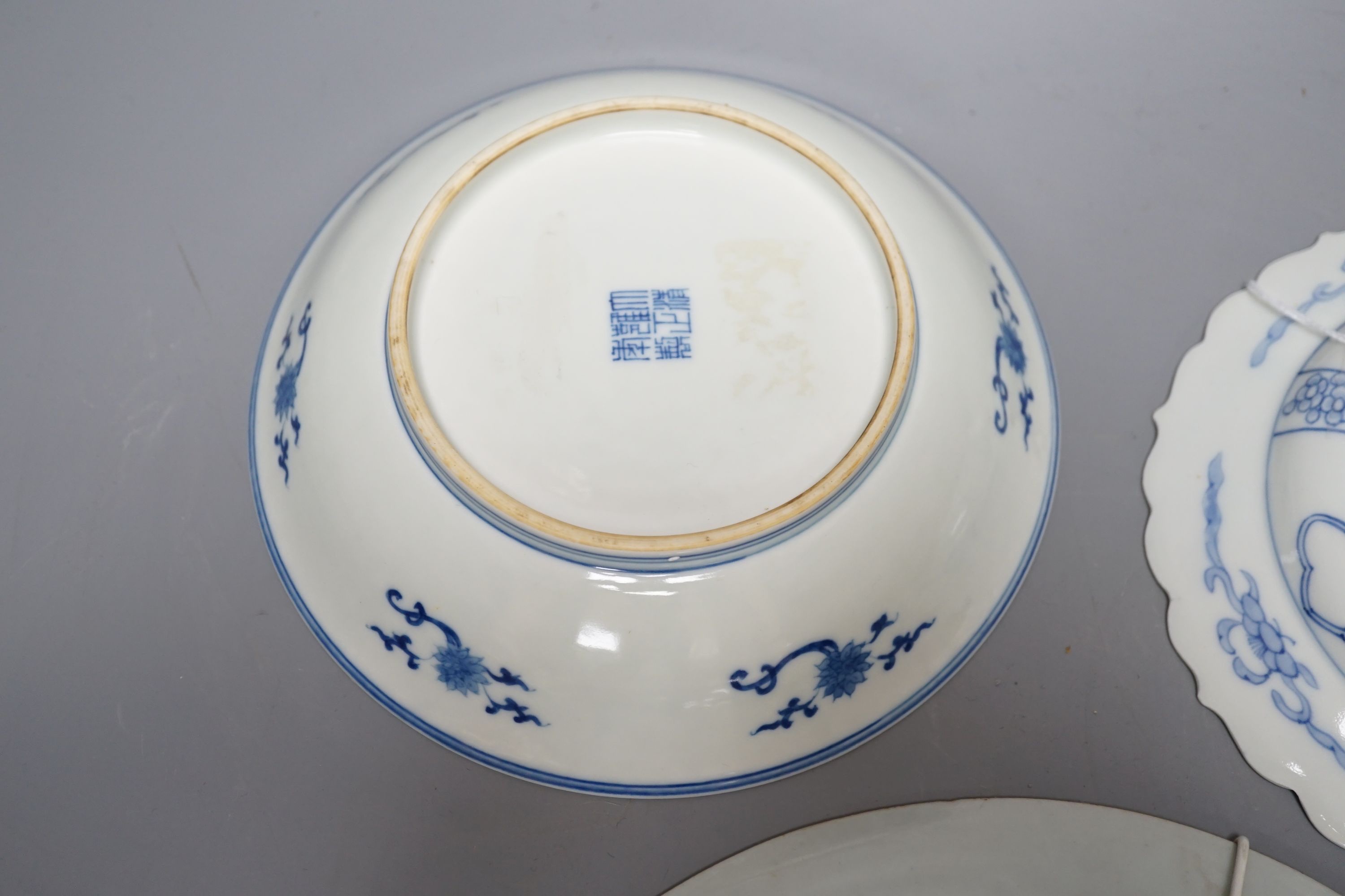 Three Chinese plates including a 19th century Chinese Imari dish, 23cm - repaired, a Chinese famille rose crackleglaze vase, 29cm, together with a famille rose teapot and a crackleglaze celadon ground bottle vase. Talles